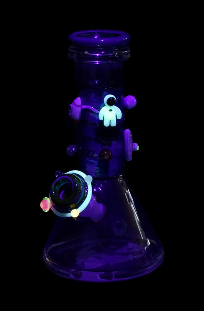 Front view of the Empire Glassworks Baby Beaker Water Pipe - Galaxy, displaying swirling blue and purple hues within its glass form.