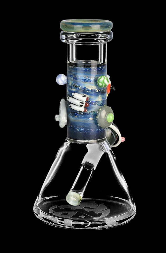 Front view of the Empire Glassworks Baby Beaker Water Pipe - Galaxy, showing a colorful, patterned glass beaker against a dark background.