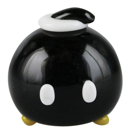 The Empire Glassworks Time Bomb Spoon is shown in a close-up, front view with a rounded shape and dark glass.