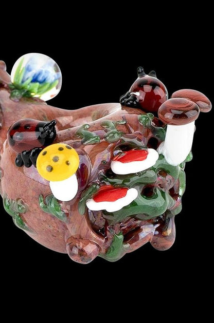 The Empire Glassworks Spoon Pipe - Nature features a sculpted, colorful glass bowl resembling mushrooms and foliage, viewed from a slight angle.