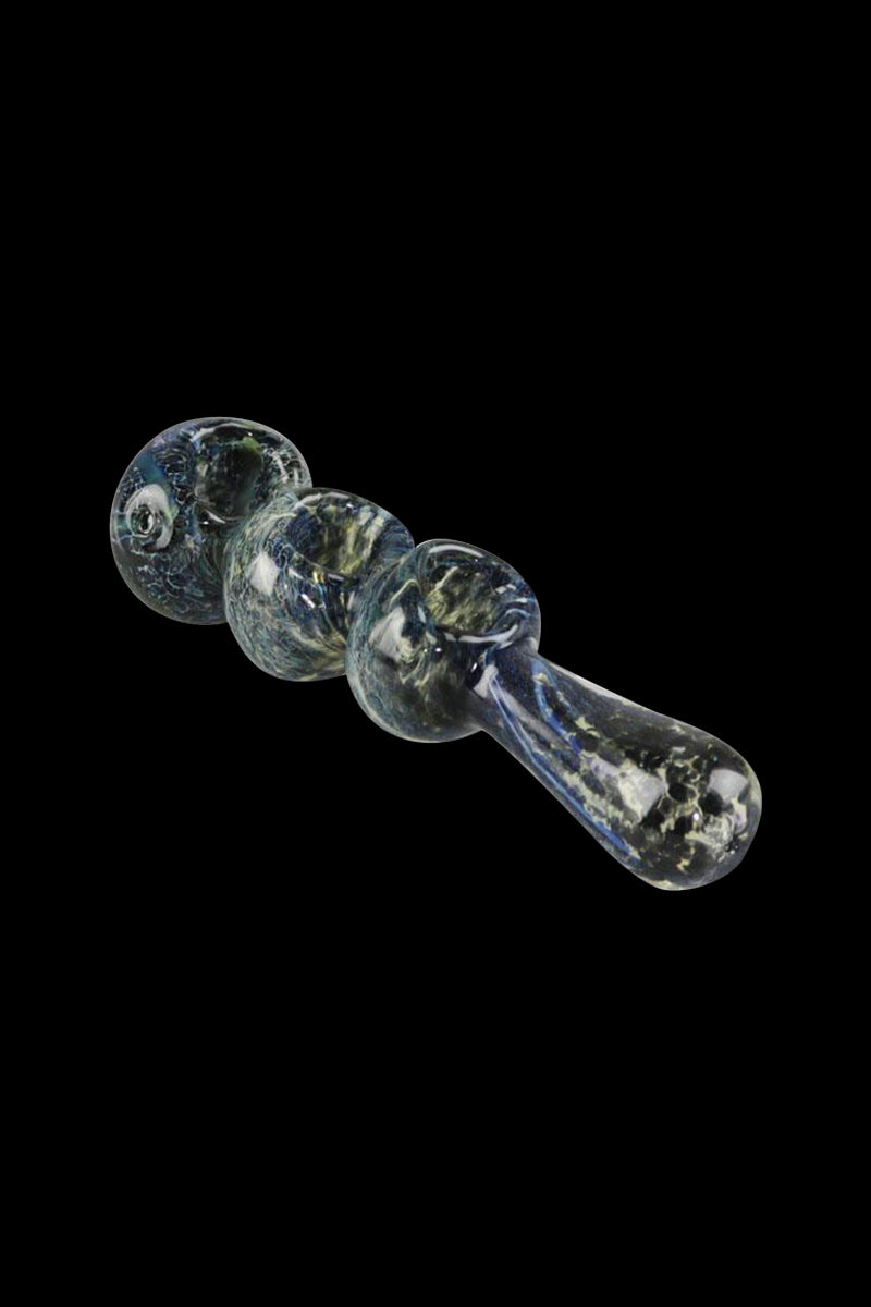 A three-bowl Fermion Skin Triple Bowl Spoon Pipe is displayed in a side view, showcasing its curved shape and textured glass.