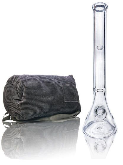 Front view of the Tank Glass "MAX" Beaker Bong with a dark-colored cylindrical object next to it on a reflective surface.