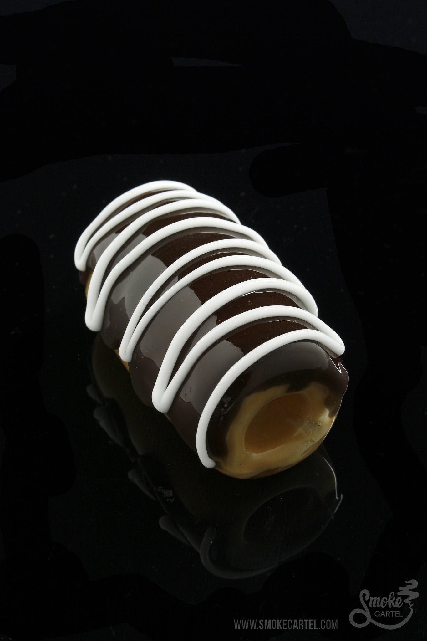 A close-up, angled view of the Glassheads “Sweet Eclair” Chillum, featuring a layered, creamy white design on a dark background.