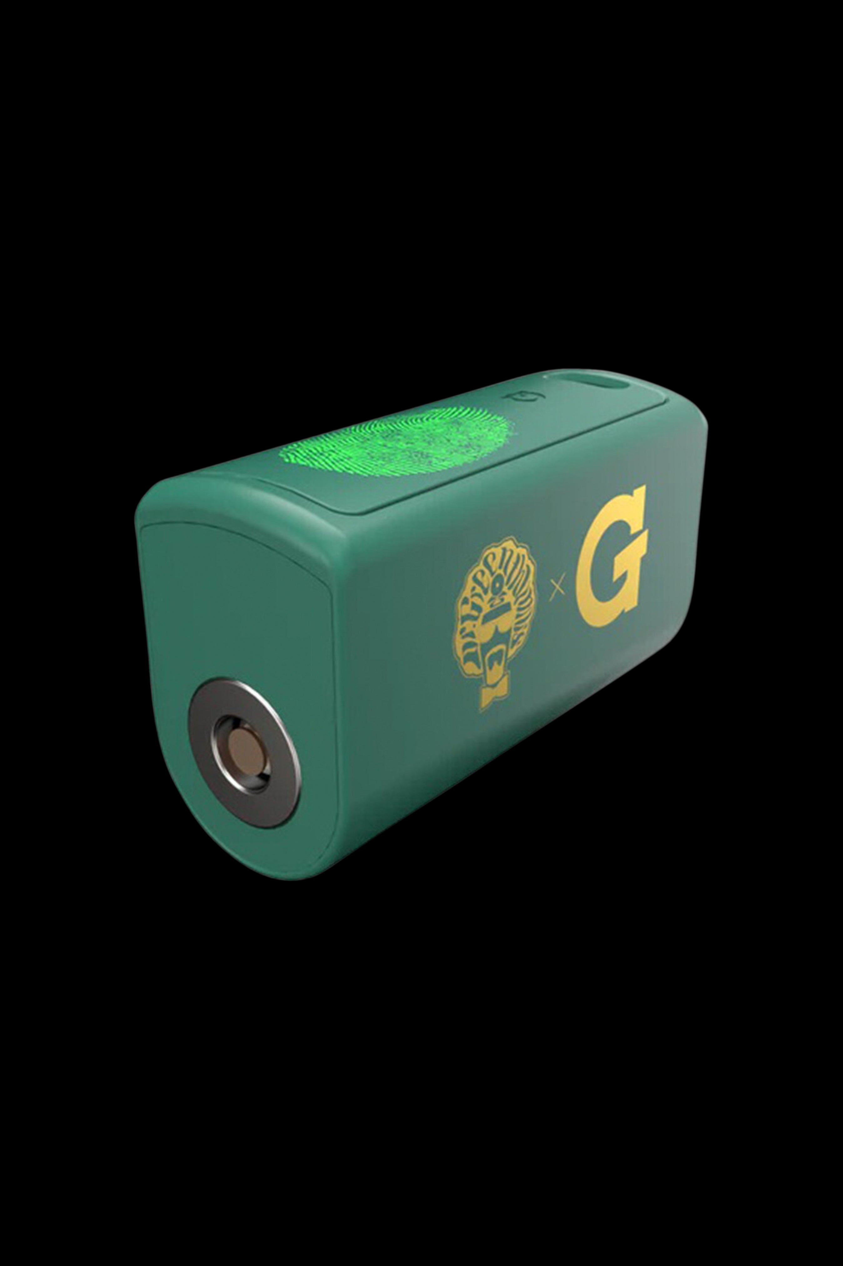 Green cannabis wax vaporizer with gold detailing and a stylized logo.