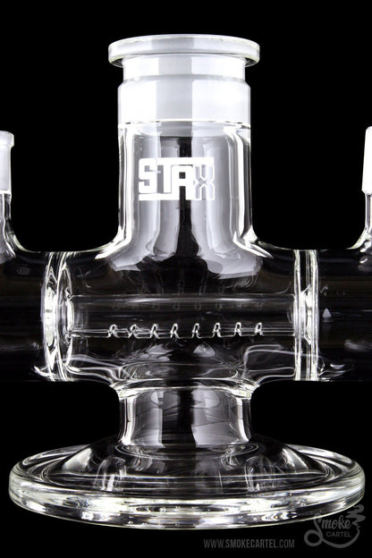 Front view of the GRAV® STAX Dual Action Inline Base, a clear glass piece with a complex geometric arrangement.