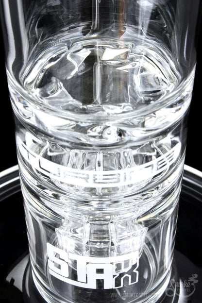 A close-up, angled view of the GRAV® STAX Flare Stemless Base with Turbine Disc, showing its clear glass construction and internal disc.