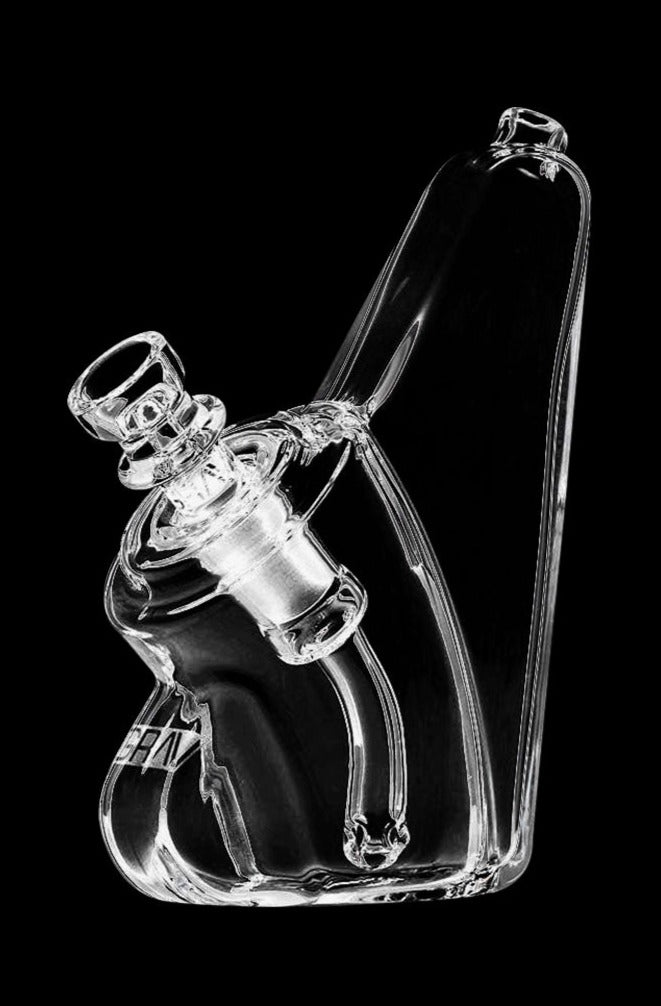 A side view of the GRAV® Wedge Bubbler, showcasing its clear glass construction and curved design against a black background.