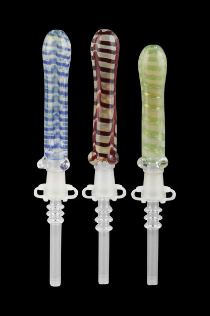 Three colorful glass dab tools with detailed, ornamental handles and clear tips, displayed against a black background.