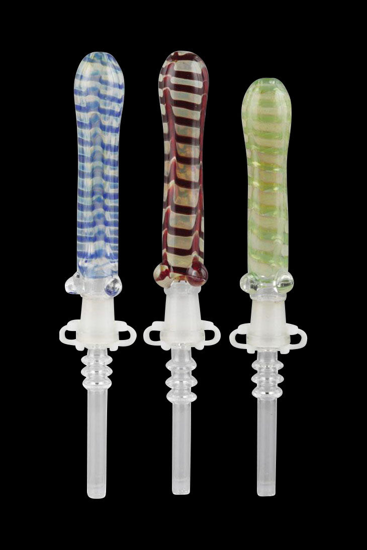 Three colorful glass dab tools with detailed, ornamental handles and clear tips, displayed against a black background.