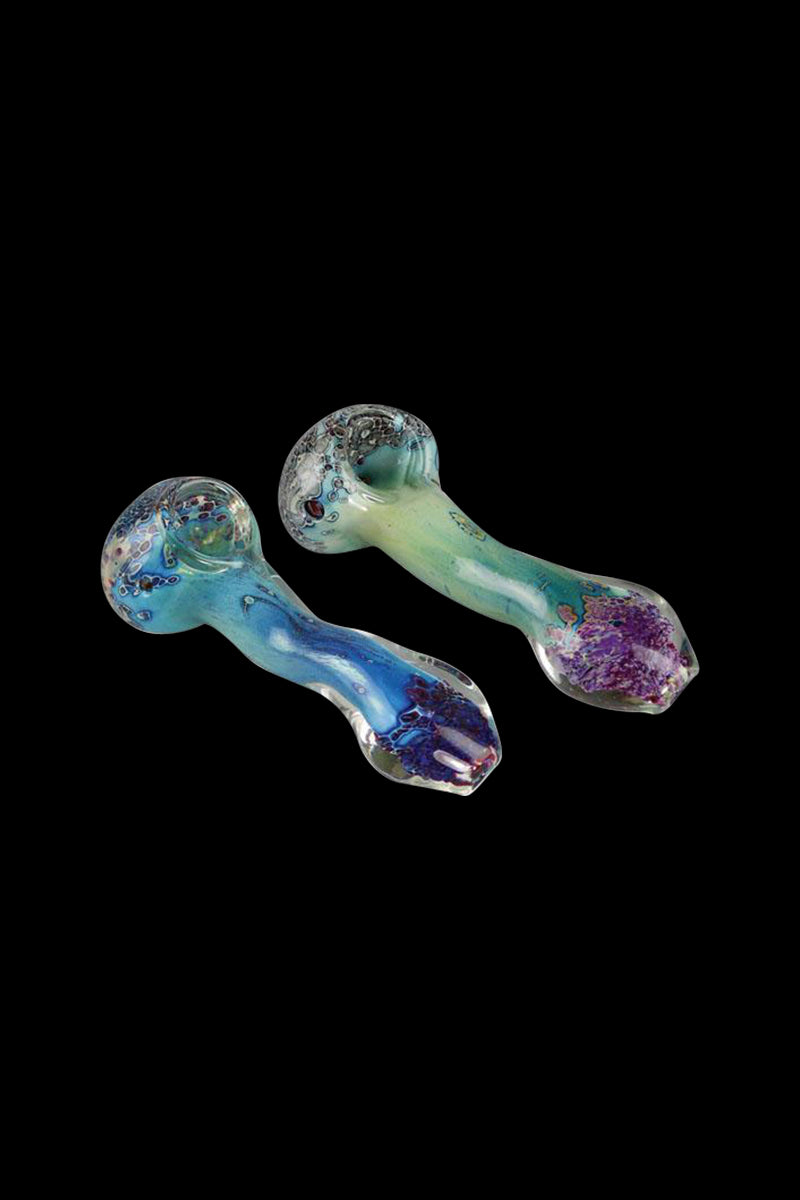 A close-up shows the Silver Fumed Spoon Pipe with a vibrant, swirling pattern against a dark background.