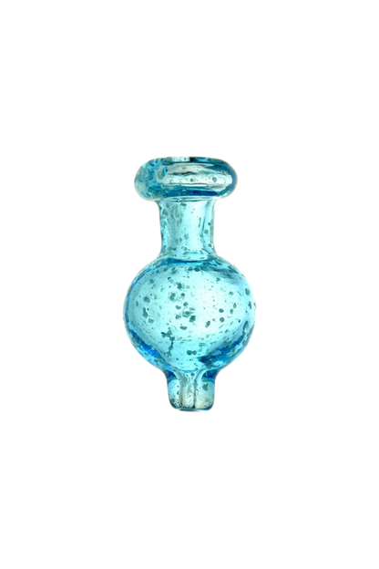 A close-up, angled view of the Glow in the Dark Speckled Ball Carb Cap, showcasing its speckled pattern and rounded glass form.