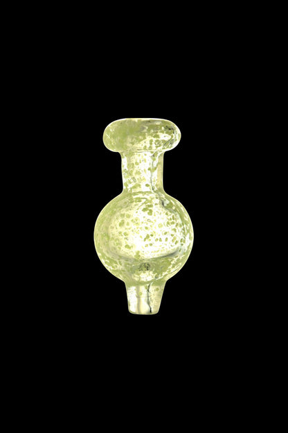 A close-up, angled view of the Glow in the Dark Speckled Ball Carb Cap, showcasing its speckled pattern and rounded shape.