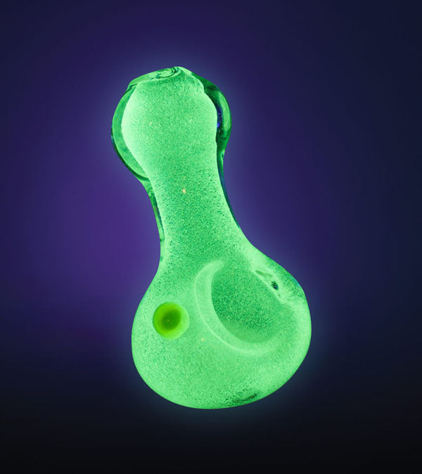 Front view of the Glow Pinch Tip Spoon Hand Pipe, a green glass pipe with a pinched tip, set against a dark background.