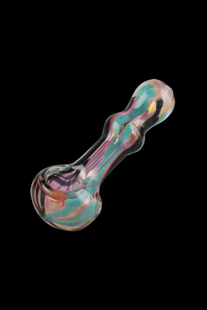 A slightly angled view of the Gold Fumed Wig-wag Hand Pipe, featuring a colorful, swirled glass design.