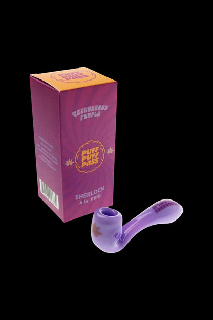 A studio shot of the "Puff Puff Pass "Granddaddy Purple" Strain Pipe" with a purple hue, angled slightly to showcase its curved design.