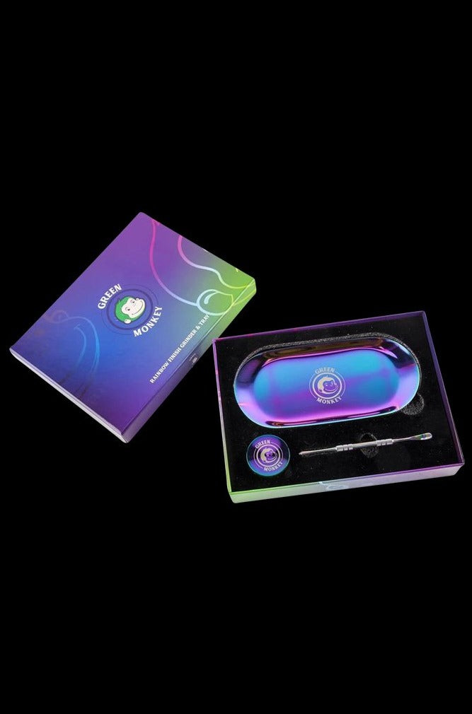 Front view of the Green Monkey Rainbow Finish Rolling Tray & Grinder Kit, showcasing its vibrant, colorful finish on a black surface.