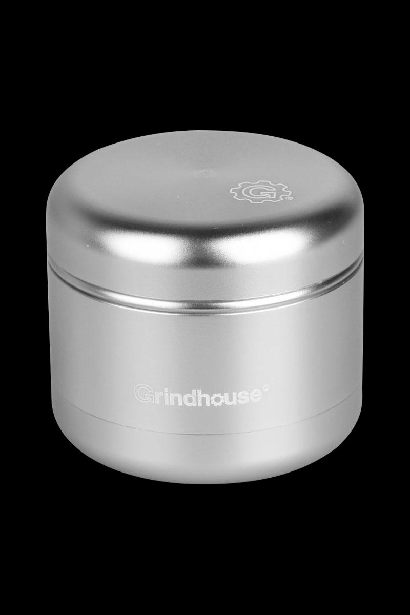 A close-up, angled view of the matte silver Pulsar 4 Piece Grinder, showcasing its cylindrical shape and metallic finish.