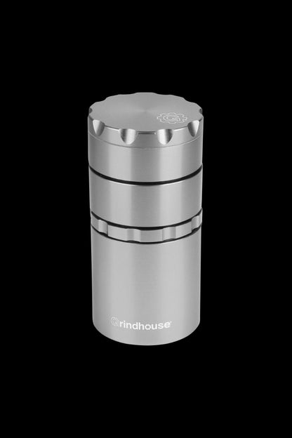 Front view of the Pulsar Metal Storage and 4-Piece Grinder, a sleek, cylindrical silver grinder against a dark background.