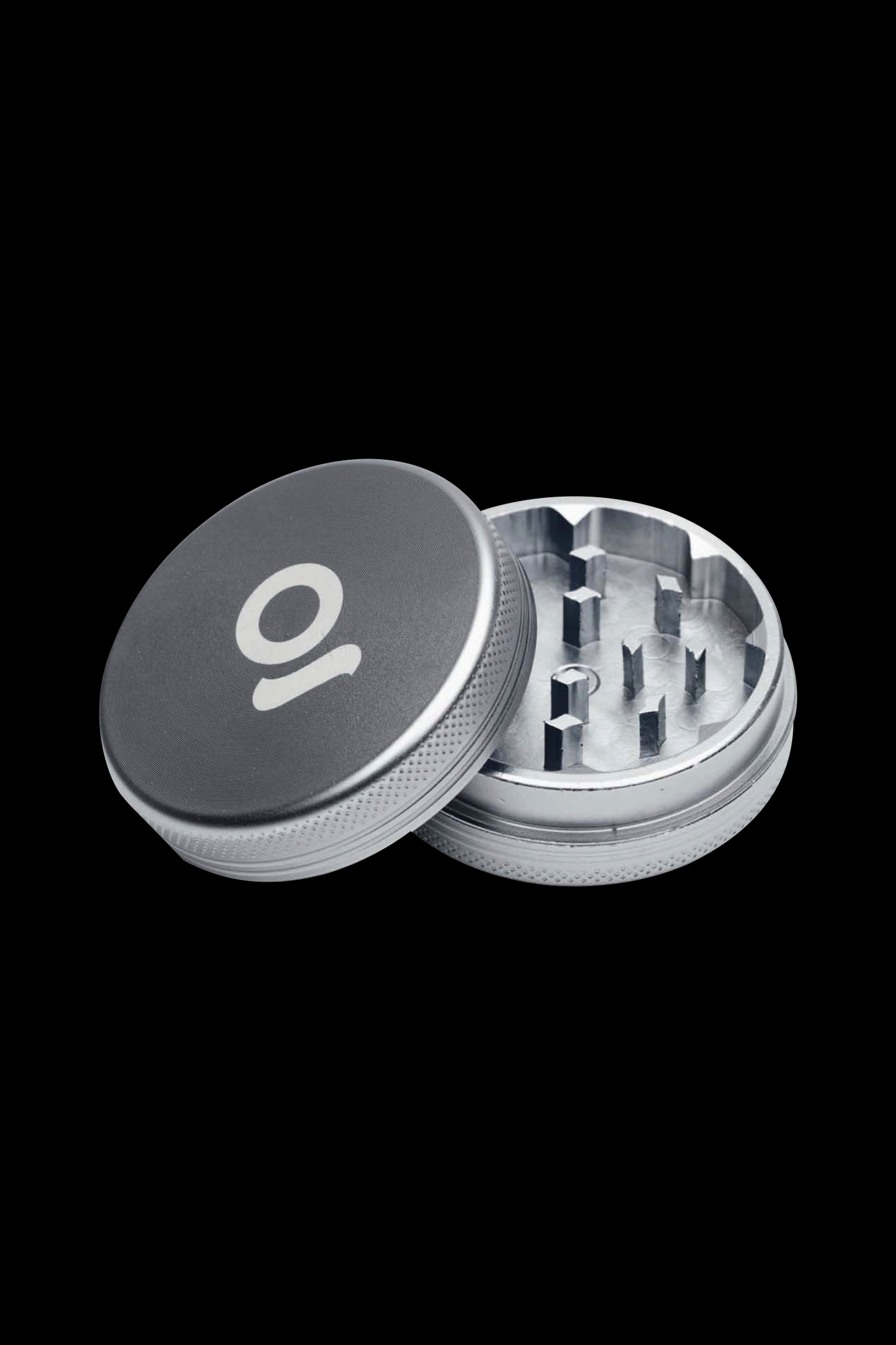 Silver and black cannabis grinder with lid removed, revealing internal grinding teeth.