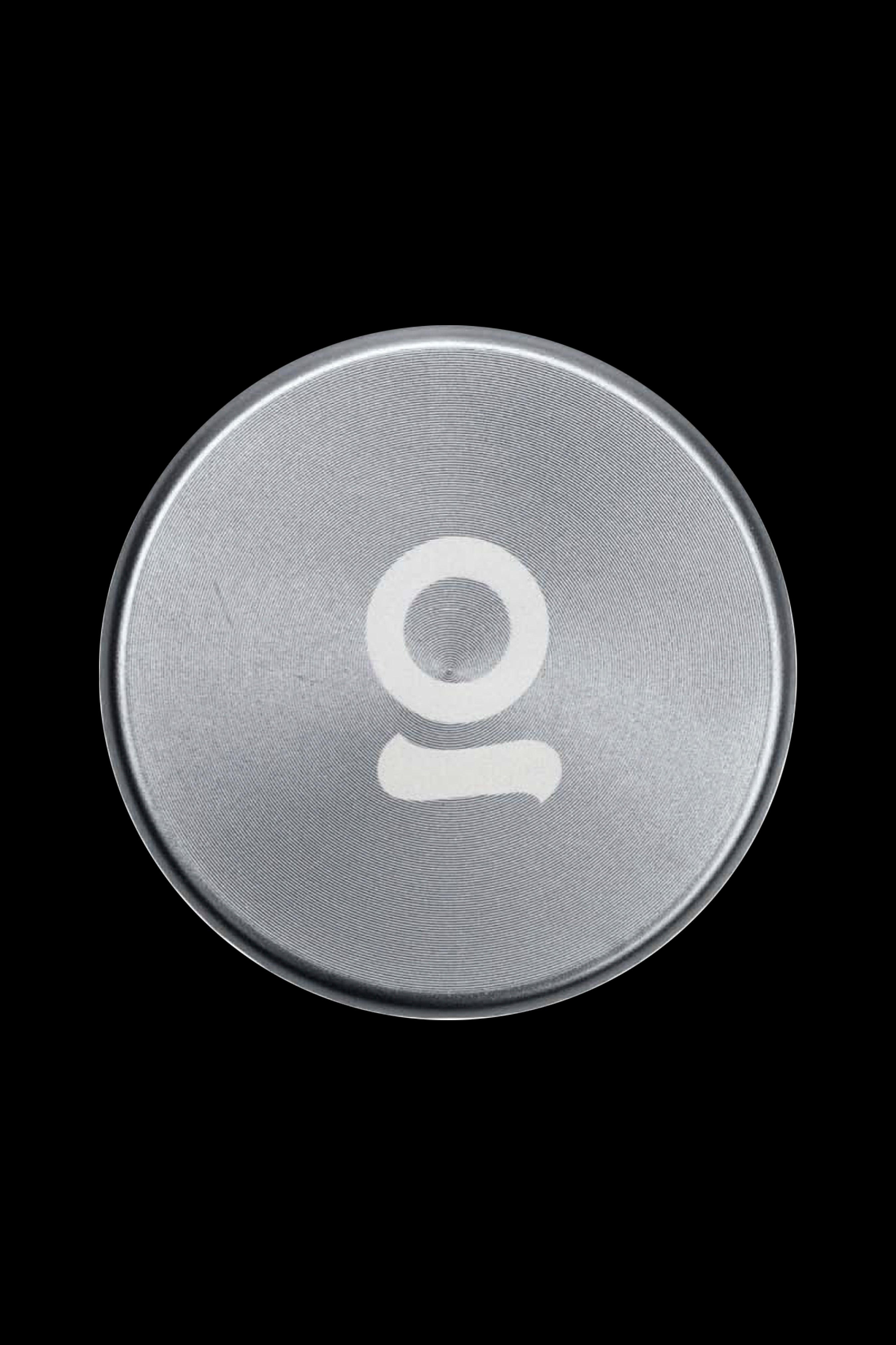 Silver cannabis accessory lid with a white “O” logo.