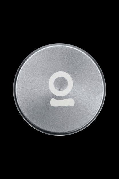 Silver cannabis accessory lid with a white “O” logo.