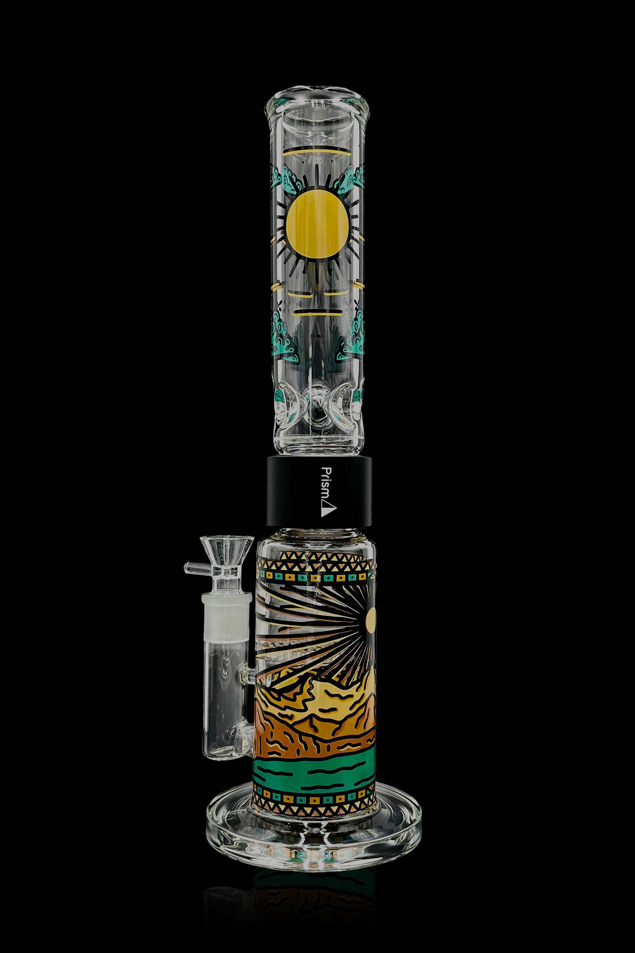 A colorful glass water pipe (bong) with a patterned design and a separate glass bowl, isolated on a black background.