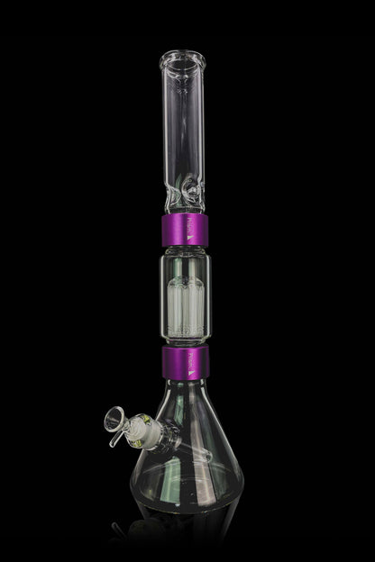 Clear glass bong with purple accents and intricate percolators, displayed against a black background.