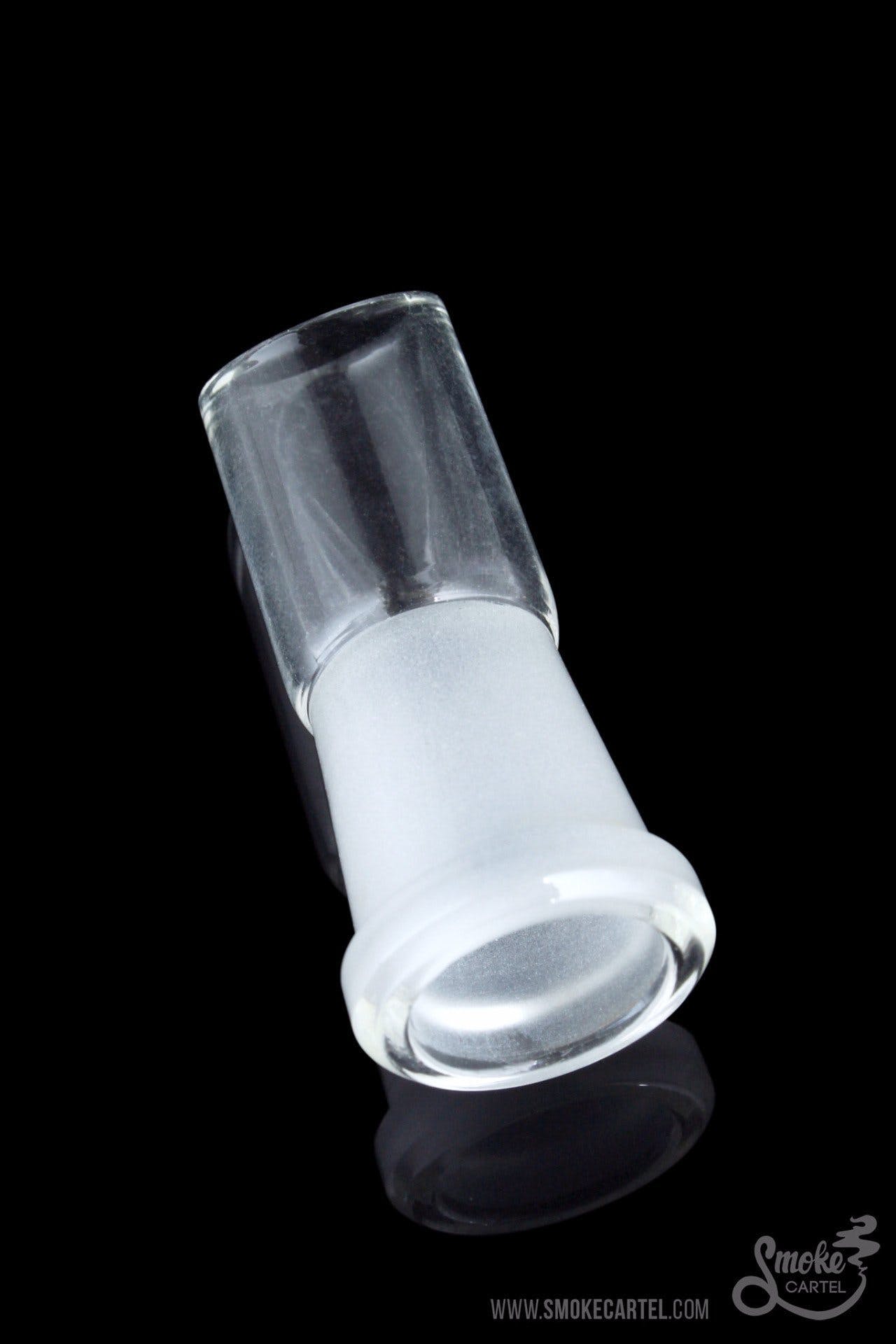 The Angled Cut Vapor Dome sits angled on a reflective surface, showcasing its clear glass construction.