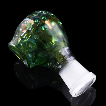 Green and iridescent glass cannabis water pipe attachment against a black background.