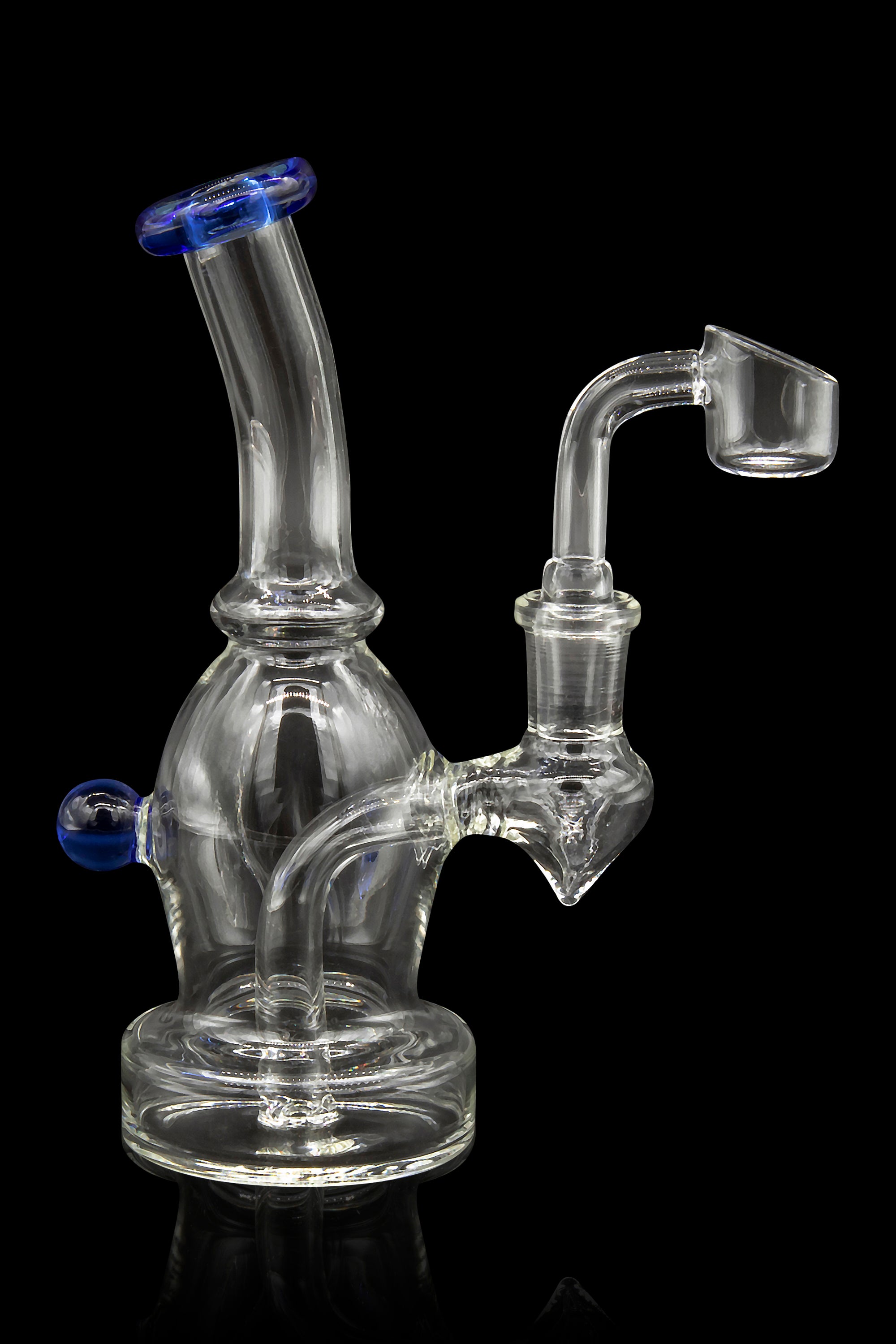 Clear glass dab rig with a bent neck and quartz banger, isolated on a black background.
