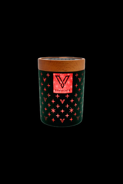 Green cannabis storage container with “Syndicate” logo and red starburst pattern, isolated on black.