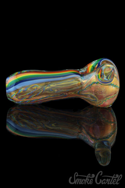 A side view of the Heavy Cane Worked Rainbow Spoon - Rainbow Mega Pipe, featuring vibrant rainbow swirls in the glass.
