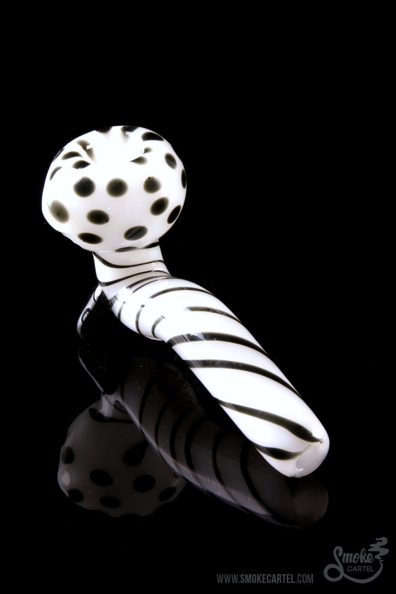 A studio shot of the Mr. Magnificent Sherlock pipe, featuring a white and black patterned design.