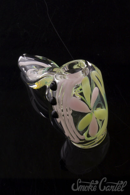 A close-up, angled view of the Green Slyme and Bubble Gum Inside-Out Pipe with Black Marbles, featuring colorful glass swirls.