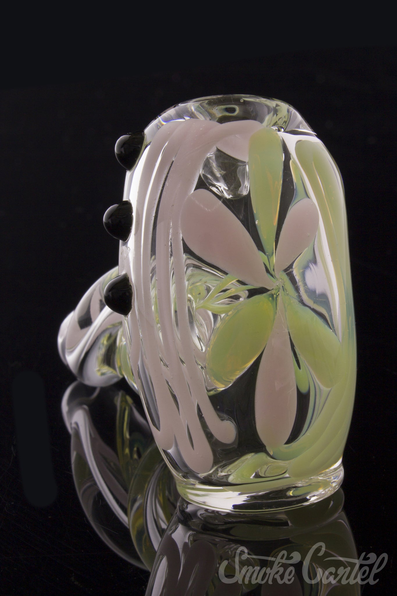 A close-up, angled view of the Green Slyme and Bubble Gum Inside-Out Pipe with Black Marbles, showcasing its colorful glass swirls.