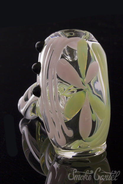 A close-up, angled view of the Green Slyme and Bubble Gum Inside-Out Pipe with Black Marbles, showcasing its colorful glass swirls.