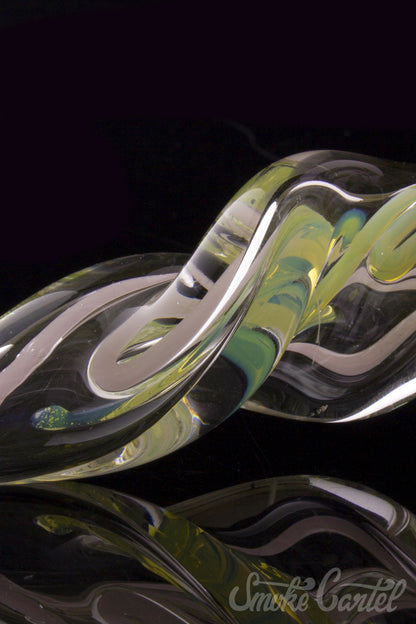 Close-up view of the Green Slyme and Bubble Gum Inside-Out Pipe with Black Marbles, showcasing its swirling glass design.
