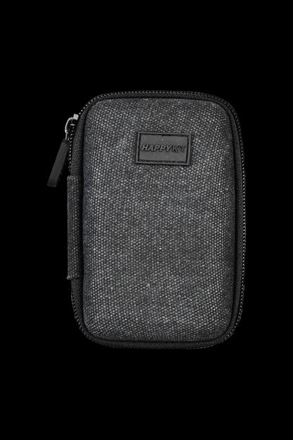 A close-up shot of The Happy Dab Kit Mini, showcasing its textured black exterior and compact zippered design.