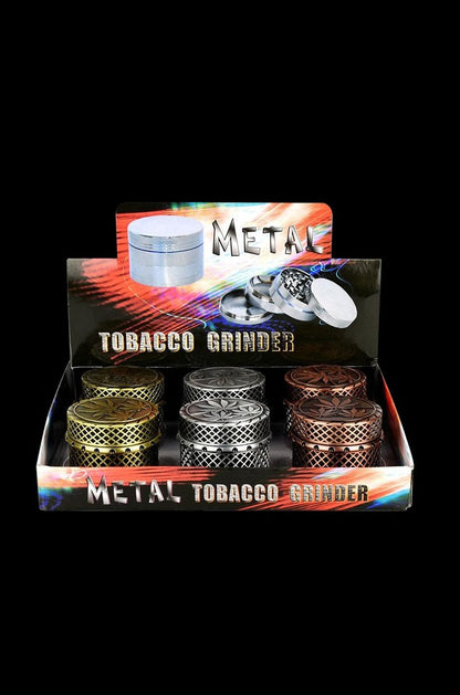 A close-up, overhead shot of the 4-Piece Metal Grinder - 6 Pack, showcasing the silver grinders stacked on a dark surface.