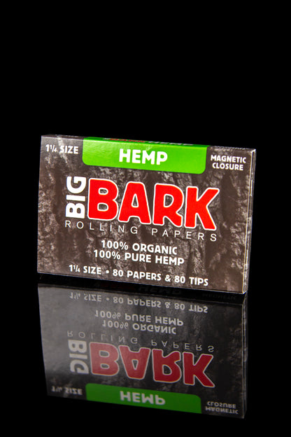 A box of “Big Bark” hemp rolling papers with a reflective surface, displaying “1 1/4 Size – 80 Papers & 80 Tips” and “100% Organic 100% Pure Hemp.” 