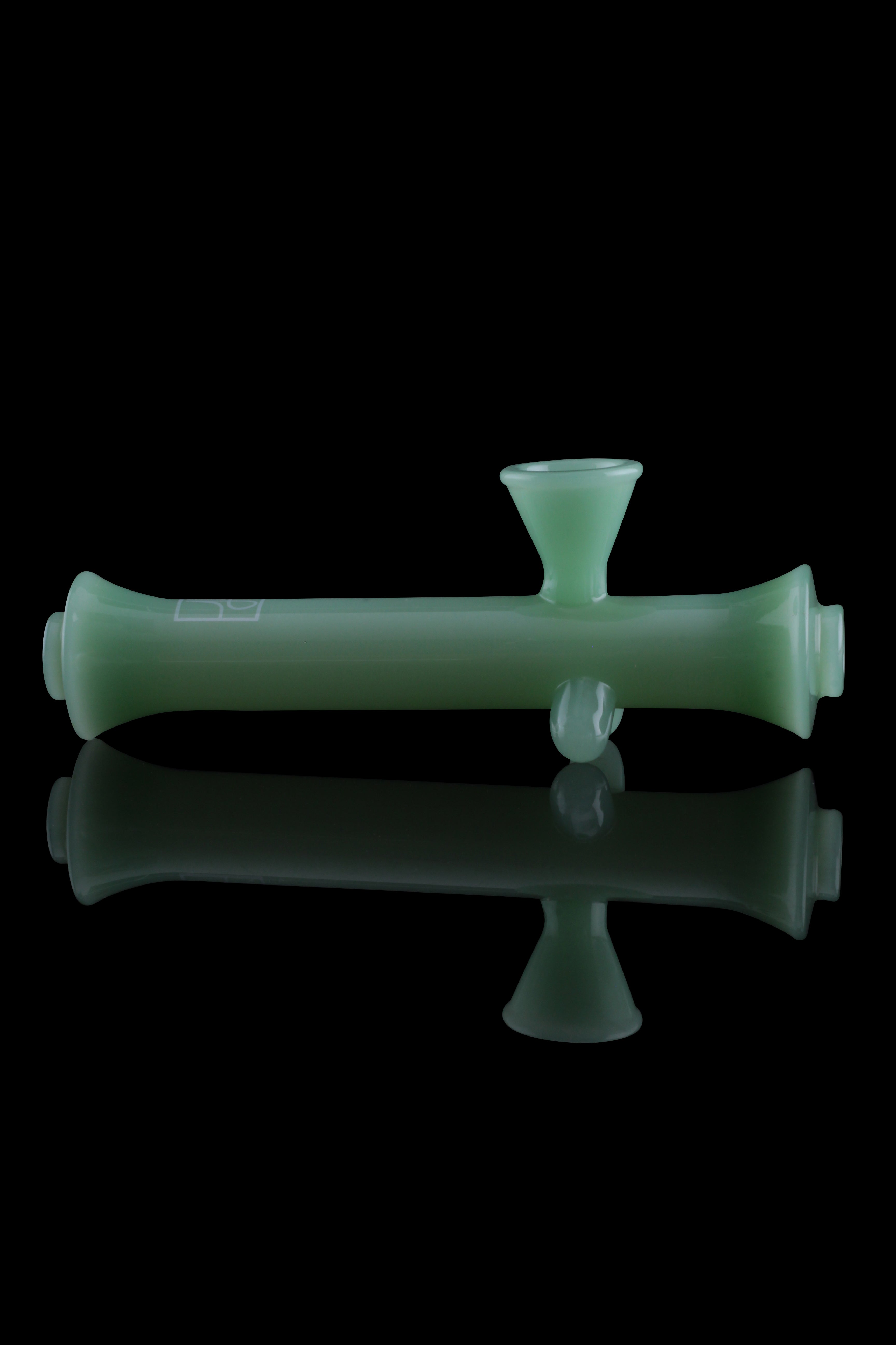 Green glass bubbler with reflection.