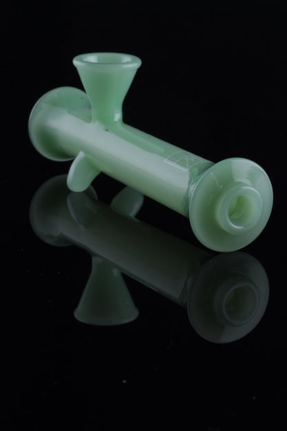 Green glass bubbler with reflective surface.