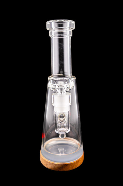 Clear glass water pipe (rig) with a wooden base, isolated on a black background.