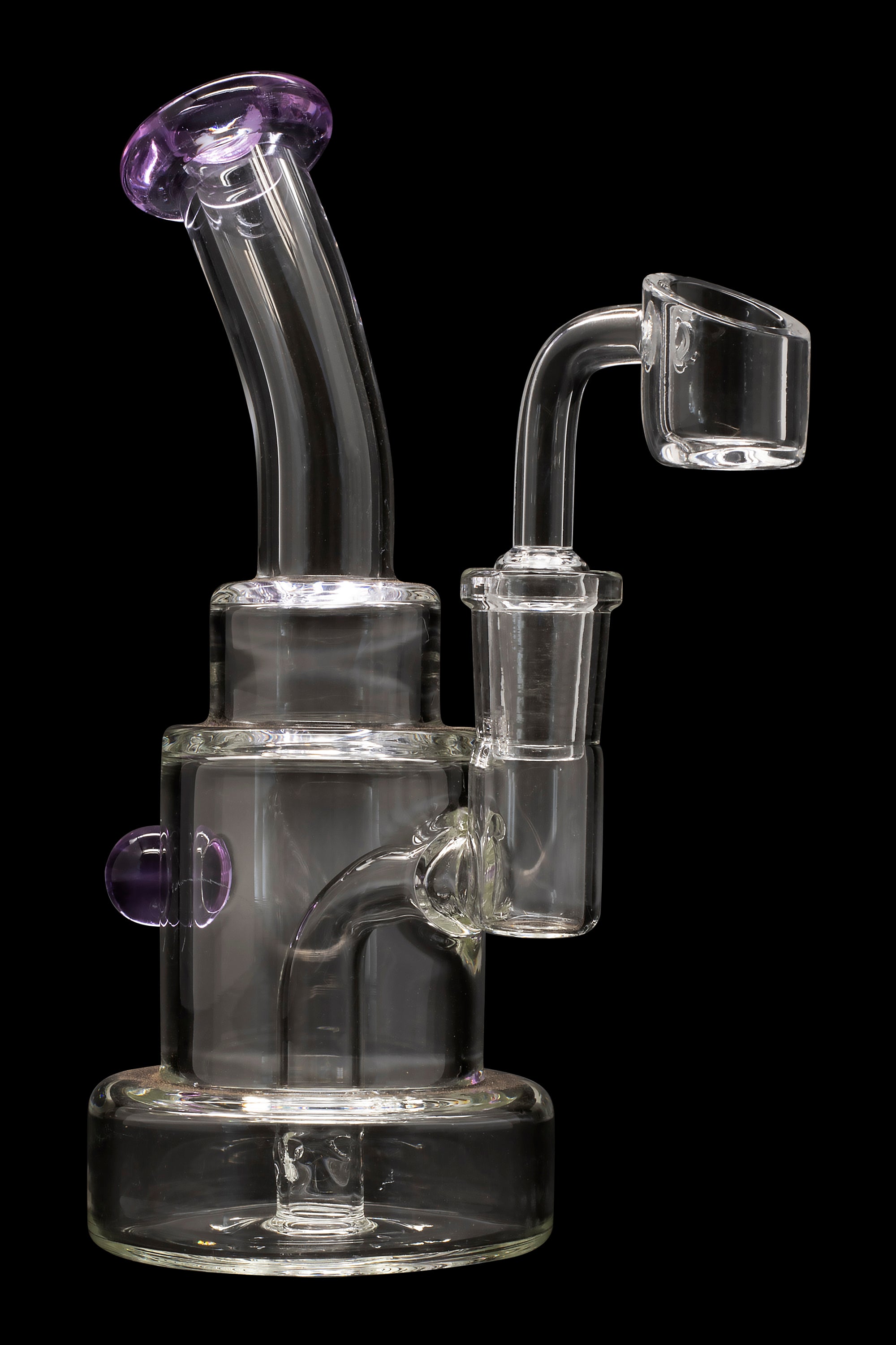 Clear glass dab rig with purple accents and a quartz banger.