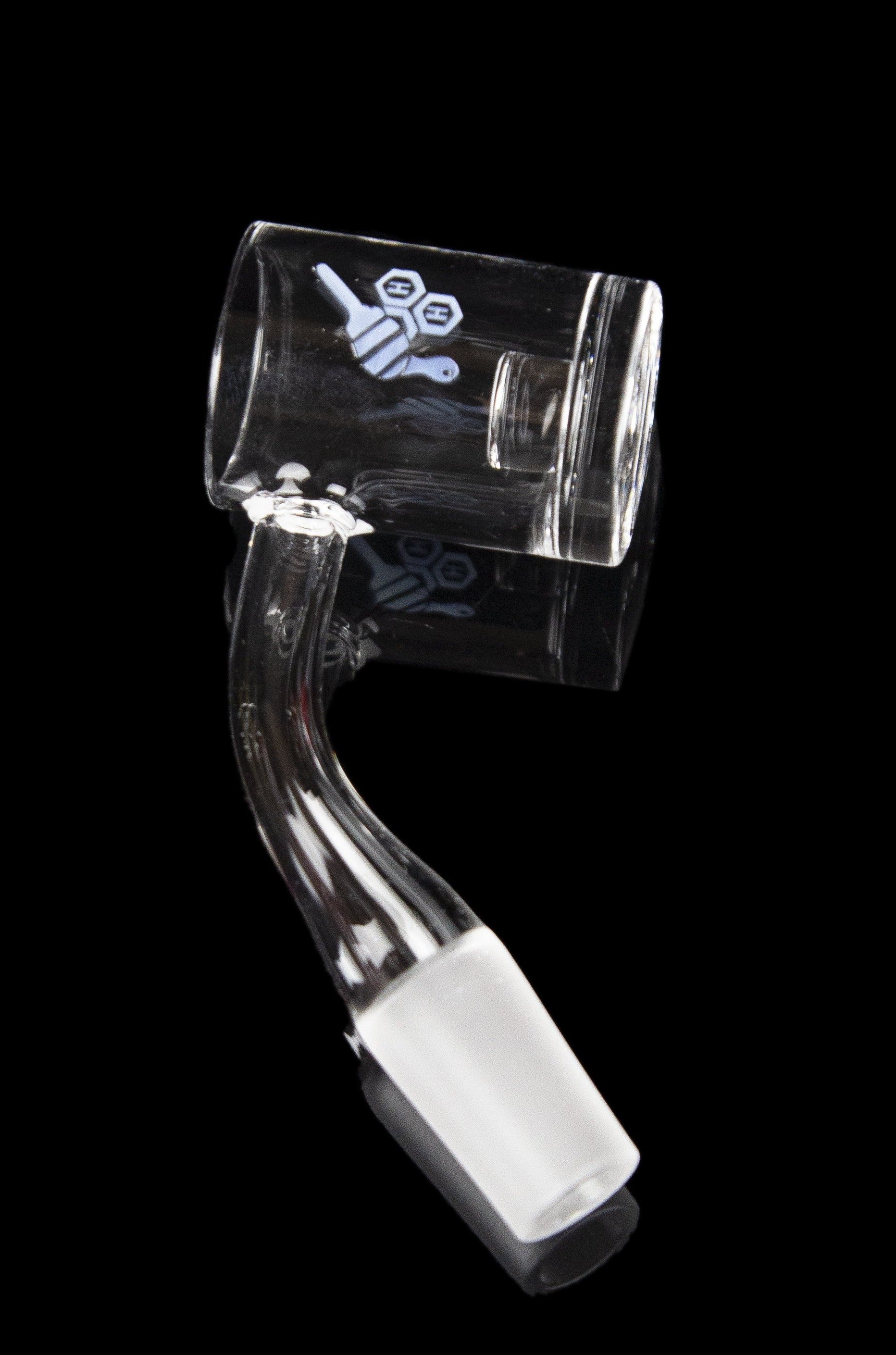 Clear glass dab rig with intricate design, isolated on a black background.