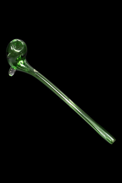 Green glass cannabis oil burner pipe against a black background.