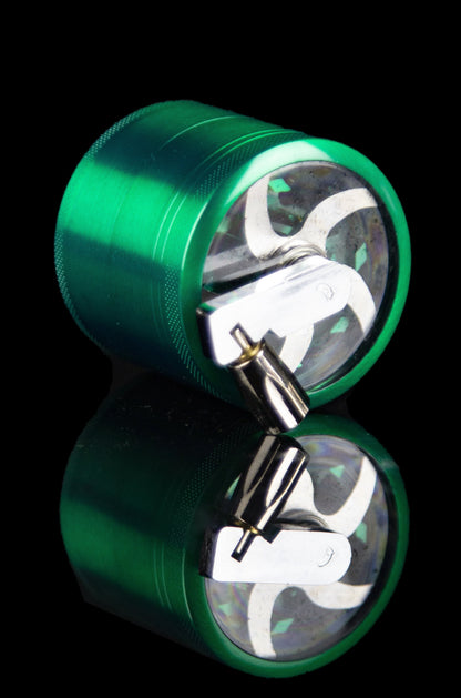 Green metal cannabis grinder, disassembled to show inner grinding components.