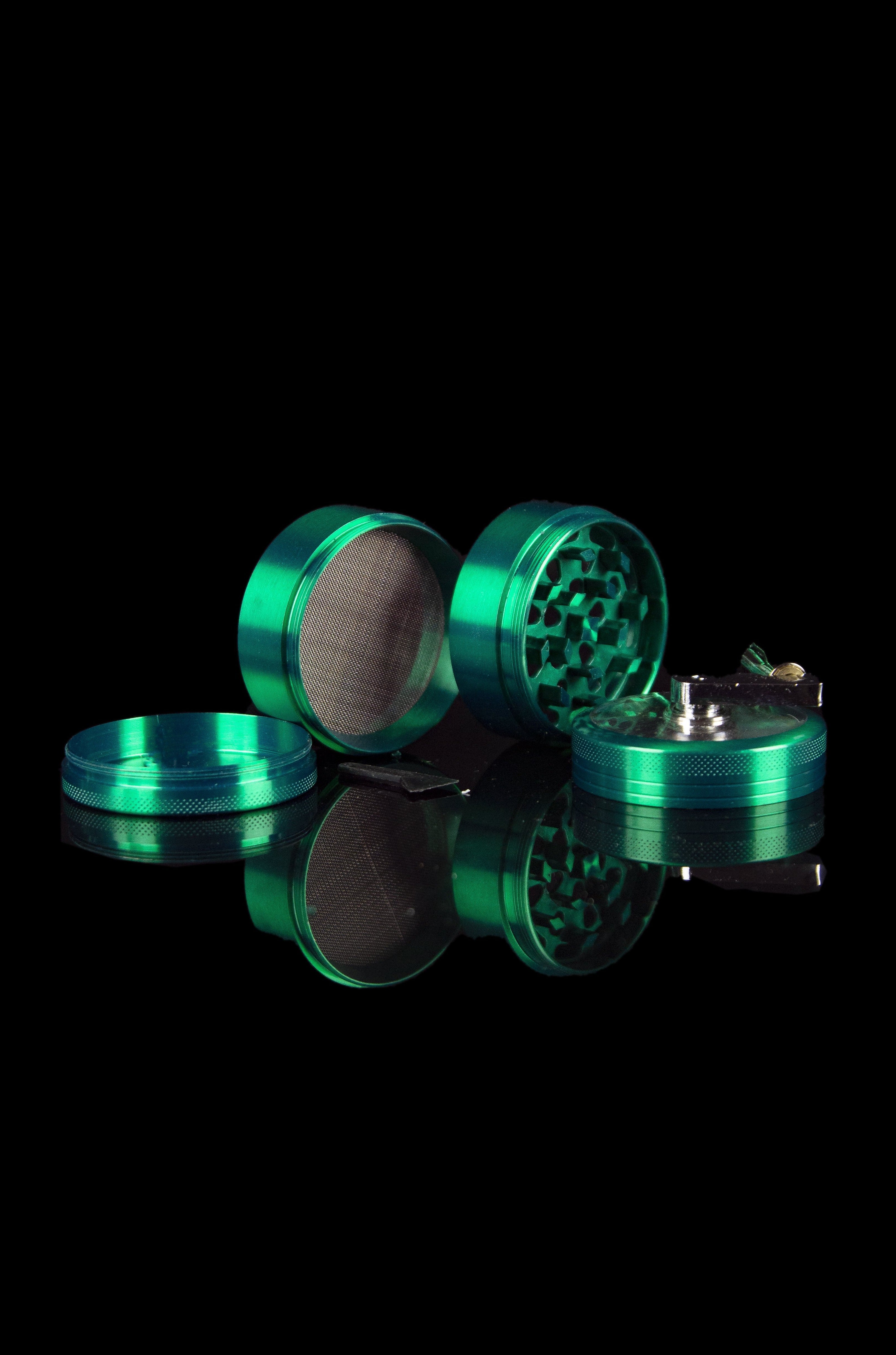 Teardown view of a teal four-piece cannabis grinder with reflective surface.