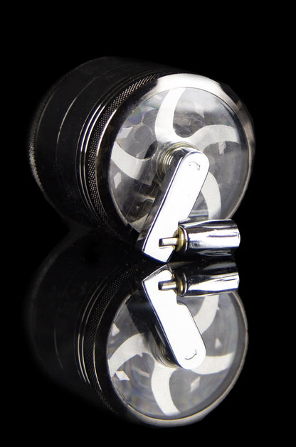 Clear glass grinder with black metal base and reflective surface.