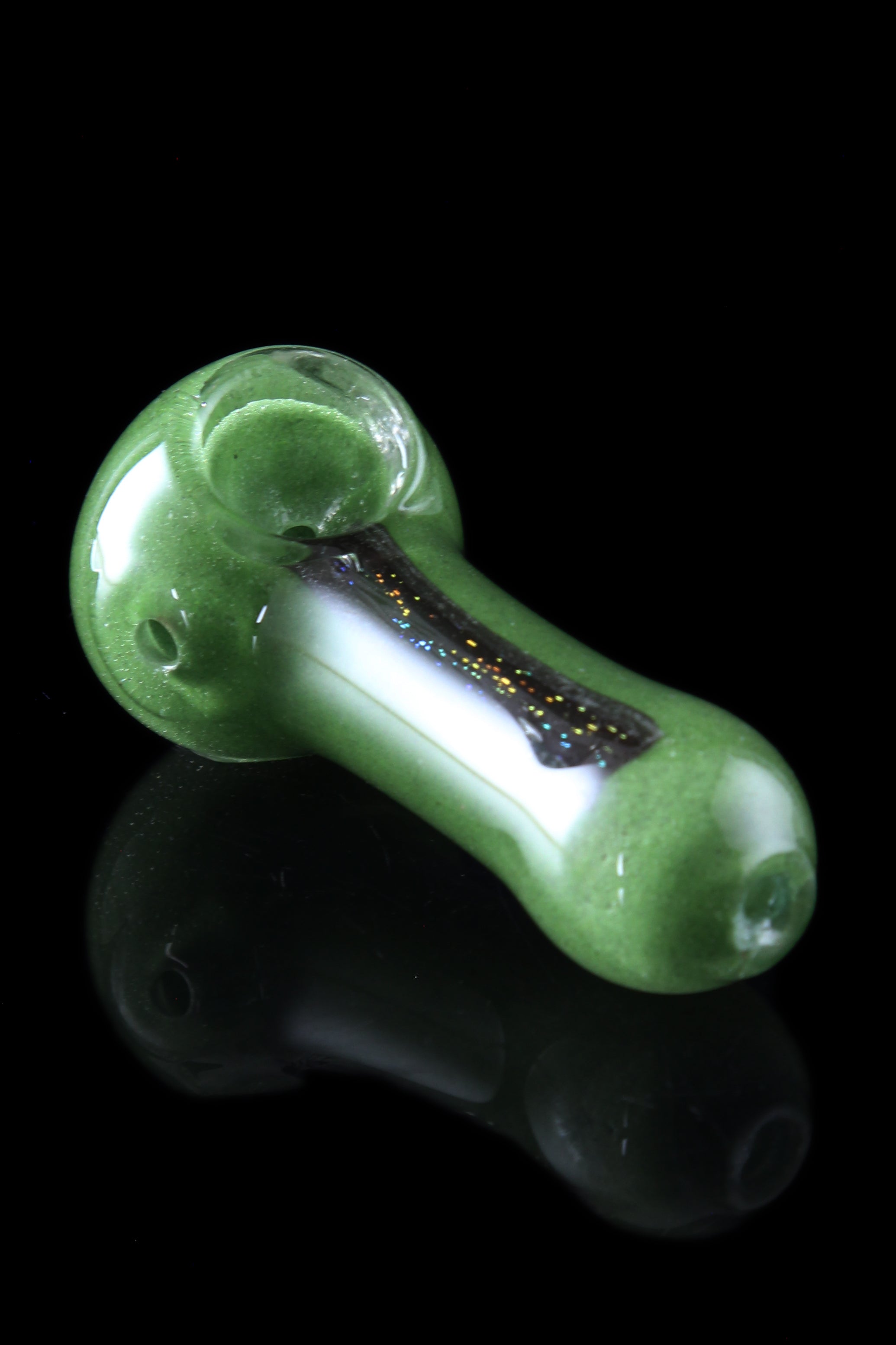 A side view of the Glassheads "Dichro Strip" Spoon, displaying an iridescent stripe on the clear glass pipe.